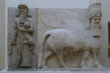 Assyrian human-headed winged bull with another who's got an unhappy kitty