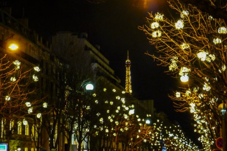 Beautifully lit street off the Champs-Élysées, with the Eiffel Tower in the background